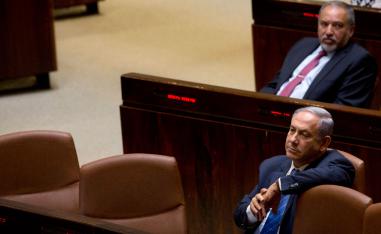 Israeli Prime Minister Benjamin Netanyahu and former Israeli Defense Minister Avigdor Lieberman sit in the Knesset