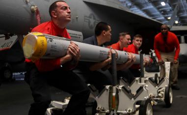 US Navy personnel transport a missile aboard the Nimitz-class aircraft carrier USS Abraham Lincoln in the Persian Gulf