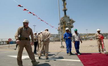 A member of security foreign personnel stays guard next to Exxon's foreign staff and Iraqi staff of the West Qurna-1 oilfield