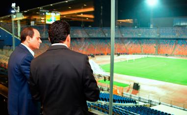 Egyptian President Abdel-Fattah el-Sissi, left, inspects Cairo Stadium