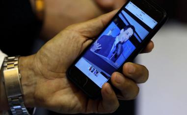 Ziad Zakka, brother of Nizar Zakka who is imprisoned in Iran, shows a photo of his brother on his cellular telephone in Beirut