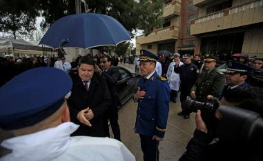 Abdelghani Hamel, former Director General of the Algerian National Police (DGSN) greets a police officer in Algiers, Algeria, March 7, 2016