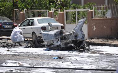 A forensic officer inspects the blast site in Reyhanli, a Turkish town in Hatay province near the border with Syria