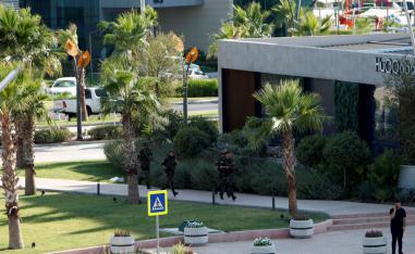 Kurdish security members are seen near a restaurant where Turkish diplomats and Turkish consulate employee were killed in Erbil