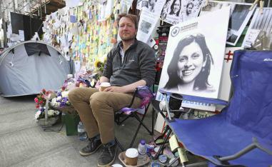 Richard Ratcliffe, the husband of detained Nazanin Zaghari Ratcliffe, with flower tributes and messages outside the Iranian Embassy in London