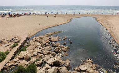 eople swim at Ramlet al-Bayda public beach near a sewage outlet in Beirut