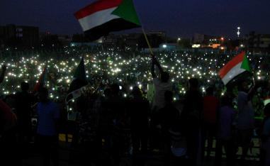 Groups of protesters sat in circles around Sudanese flags and candles in several neighbourhoods as the sun set over Khartoum.