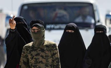 Unlike Syrian and Iraqi women who are allowed to roam the camp freely, these high-risk prisoners are escorted by armed guards
