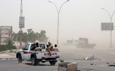 Members of UAE-backed southern Yemeni forces patrol a road during clashes with government forces in Aden, Yemen