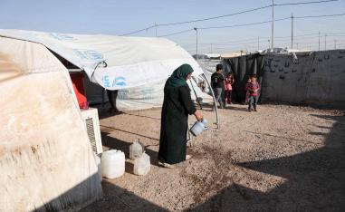  Iraqi family displaced from Mosul stands outside a tent
