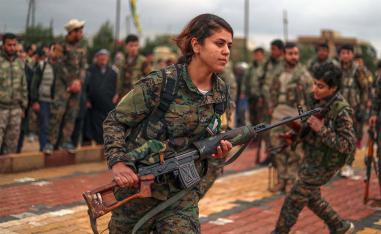 Fighters from the Kurdish women's protection units (YPJ) attend the funeral of a fellow fighter last February