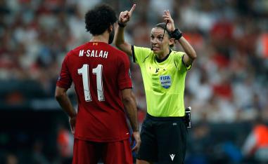 Referee Stephanie Frappart gestures as she speaks to Liverpool's Mohamed Salah during the UEFA Super Cup final in Istanbul