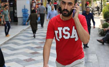A man uses his mobile telephone at the Vali Asr square in the Iranian capital Tehran