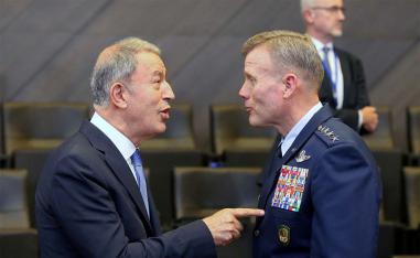 Turkish Defence Minister Hulusi Akar (L) speaks with the Supreme Allied Commander Europe, US Air Force General Tod Wolters,