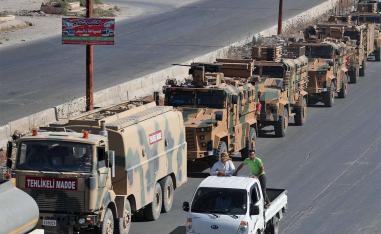 A convoy of Turkish military vehicles passes through Maaret al-Numan in Syria's northern province of Idlib reportedly heading toward the town of Khan Sheikhun