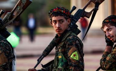 A YPG fighter holds a sniper rifle on his shoulder
