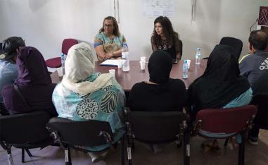 Two members of Morocco's ALCS talk with HIV patients at Ibn Rochd Hospital