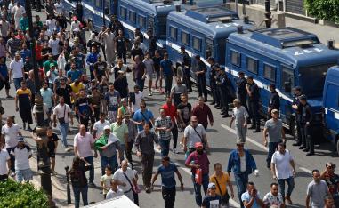 Algerian protesters take part in a demonstration against the ruling class in Algeria's capital Algiers