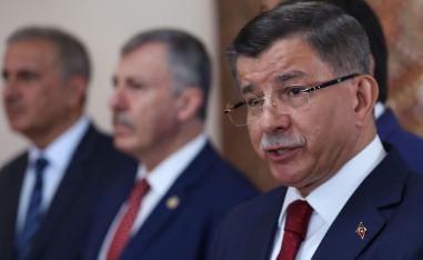 Former Turkish Prime Minister Ahmet Davutoglu (R) holds a press conference at his home in Ankara