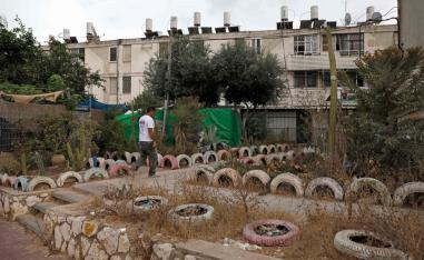 A man walks in an impoverished neighbourhood in the city of Ashkelon