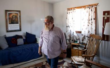 Tommy Waller, founder of US based Christian group HaYovel, walks inside his family's lodgings at the outskirts of Har Bracha settlement in the Israeli-occupied West Bank