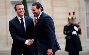 French President Emmanuel Macron welcomes Lebanese PM Saad al-Hariri as he arrives at the Elysee Palace last year