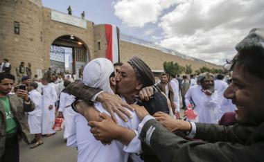 A Yemeni detainee is greeted by his relative and friends after his release from a prison controlled by Huthi rebels, in Sanaa