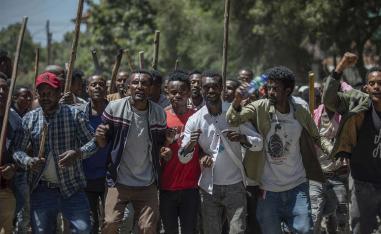 Protesters perform and shout slogans at the house of opposition leader Jawar Mohammed in Addis Ababa to show their support