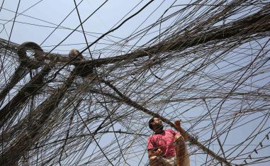 An Iraqi man checks electrical wires in Baghdad