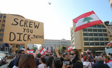 Lebanese demonstrators take part in a protest against dire economic conditions in Lebanon's southern city of Sidon
