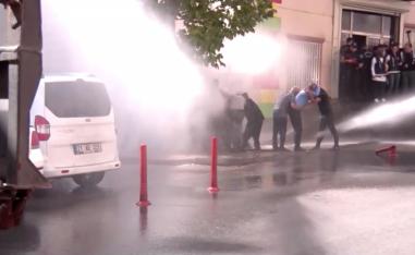 Kurds protesting Turkey's Syria operation are hit by water sprayed from a water cannon in Diyarbakir