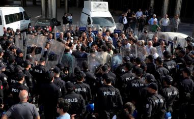 Peoples' Democratic Party (HDP) lawmakers are surrounded by riot police as they protest against detention of their local politicians in Diyarbakir