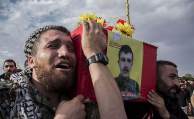 People attend funerls of Syrian Democratic Forces fighters killed recently fighting Turkish forces in the town of Hasakeh