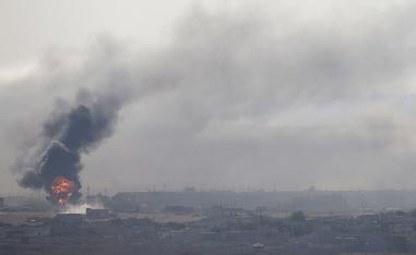 An explosion is seen over the Syrian town of Ras al-Ain as seen from the Turkish border town of Ceylanpinar
