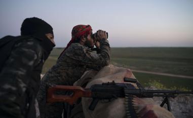 US backed Syrian Democratic Forces fighters survey a position in Baghouz, Syria