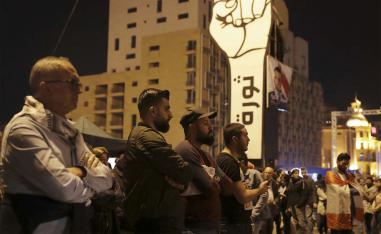 Anti-government protesters listen to Lebanese President's speech