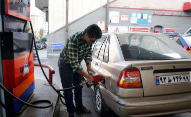 Iranian fills his vehicles at a petrol station in Tehran