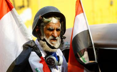 A demonstrator holds the Iraqi flag during the ongoing anti-government protests in Baghdad