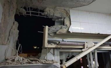 A damaged building targeted by Israeli missile strikes in Qudsaya suburb