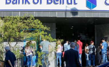 People queue outside a branch of Bank of Beirut in Ain el-Remmaneh