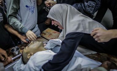 A woman mourns over the body of Zaki Ghanama, 25, in morgue at Beit Lahia northern the Gaza strip