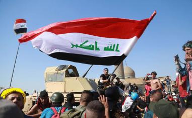 Anti-government protesters try to cross the al- Shuhada (Martyrs) bridge in central Baghdad