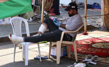 A wounded Iraqi protester resting under a tent in al-Khalani square in central Baghdad 