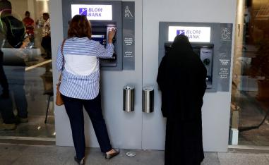 Women use ATMs at Blom bank in Beirut