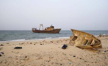 A decaying boat is seen docked off the port of Nouadhibou 