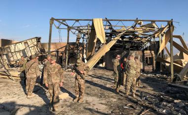 US soldiers inspect the site where an Iranian missile hit at al-Asad air base