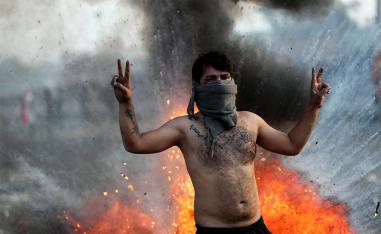 An Iraqi demonstrator gestures during ongoing anti-government protests in Baghdad