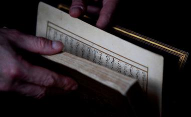 Dutch art crime investigator Arthur Brand holds a rare 15th-century copy of the 'Divan of Hafez'