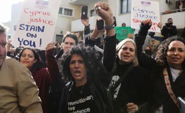 Activists take part in a demonstration outside the courthouse in Paralimni