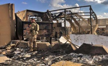 US soldiers and journalists inspect the rubble at a site of Iranian bombing, in Ain al-Asad air base, Anbar